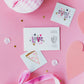 Valentine's Day temporary tattoos featuring neon colors and gold foil accents, illustrated by Jordan Sondler for Daydream Society. Package includes 2 safe, non-toxic tattoos, each measuring 2.5 inches square, packaged in a cardstock envelope. Perfect for party favors.