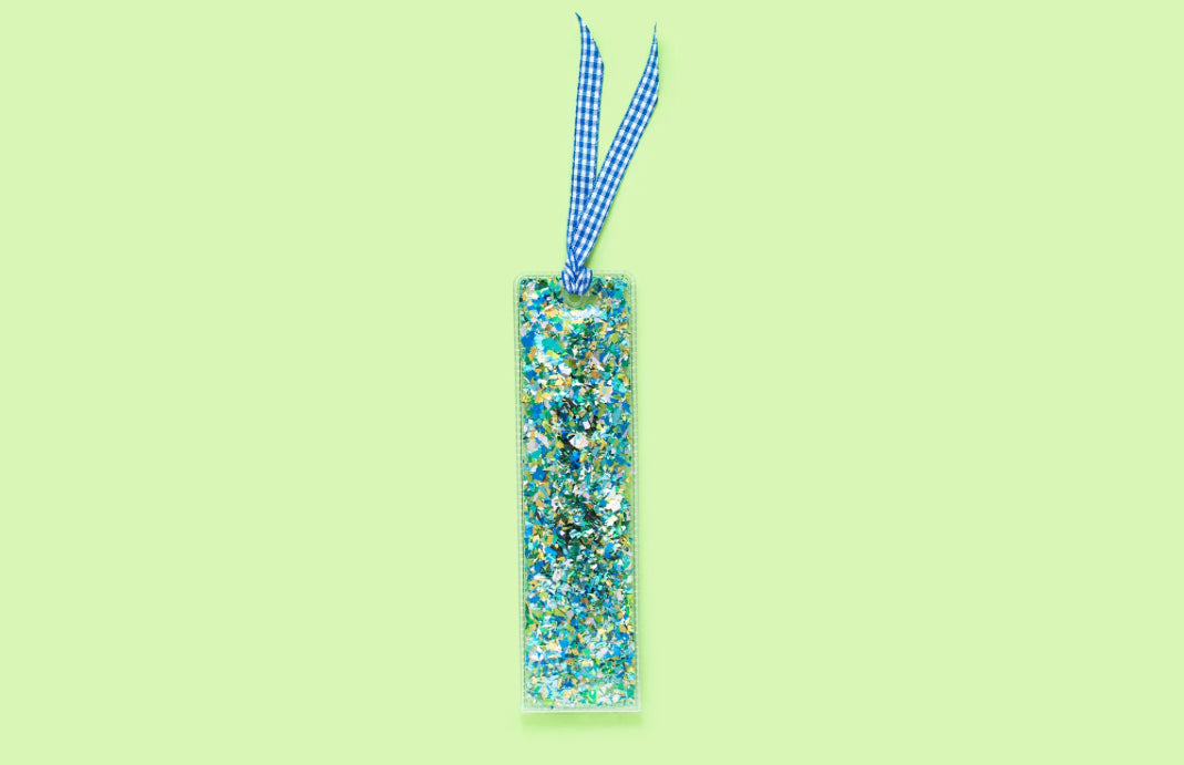 Delightful confetti bookmark for books, planners, or Bibles, measuring 2" x 7". Made of clear plastic with blue and green confetti, finished with a blue gingham ribbon.