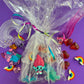 Trolls the Movie Rainbow Sensory Kit with handmade rainbow swirl glitter dough, sensory charm mix, and soft glitter pompoms. Encourages imagination, sensory development, and creative play for ages 3 and up.