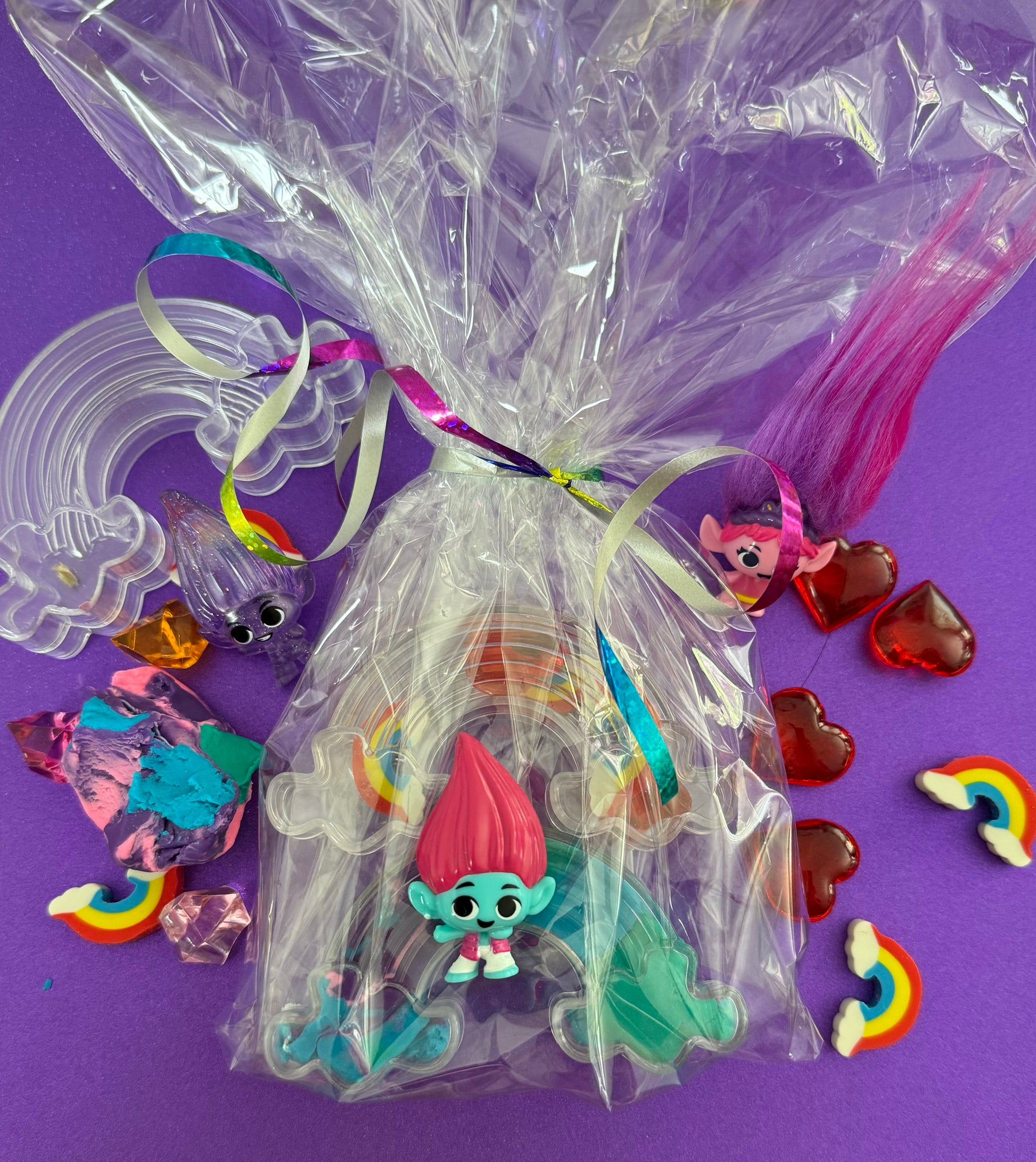 Trolls the Movie Rainbow Sensory Kit with handmade rainbow swirl glitter dough, sensory charm mix, and soft glitter pompoms. Encourages imagination, sensory development, and creative play for ages 3 and up.