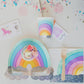 Radical rainbow paper napkins and cups set illustrated by Hello!Lucky for Daydream Society, featuring candy-like colors and glittery silver holographic foil-pressed clouds. The package contains 8 napkins and cups with a 9 oz. capacity, each cup measuring approximately 3.5 inches tall and 3 inches wide. Suitable for hot or cold beverages, withstanding temperatures up to 90-100°F. Not safe for microwave use.
