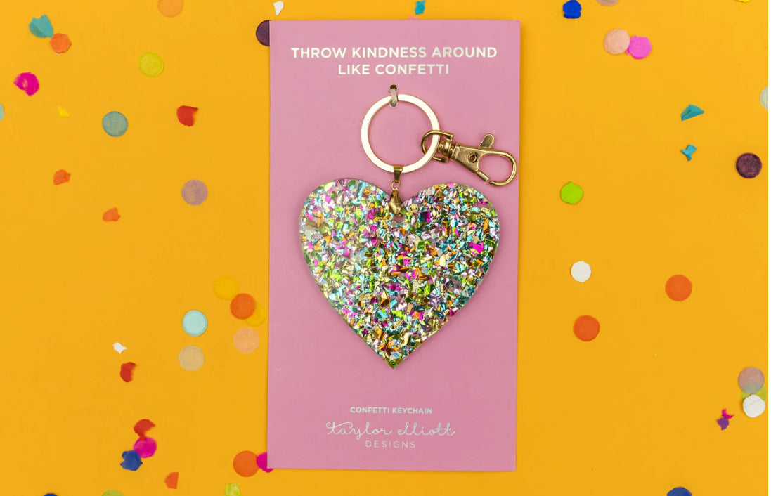 Confetti acrylic heart keychain, 3" x 3" with a gold metal keyring. Perfect for adding to keys, tote bags, or backpacks. Confetti is hand-sprinkled inside the acrylic to prevent shedding. Each piece is unique due to this process. Includes silver hologram foil.