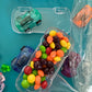 Car-themed candy favors, perfect for birthdays or playdates. Includes car-themed gummies or rainbow Skittles in a car-shaped box. Wrapped in cellophane with optional thank you label. Fun and delicious treat for any party. Custom candy containers available.