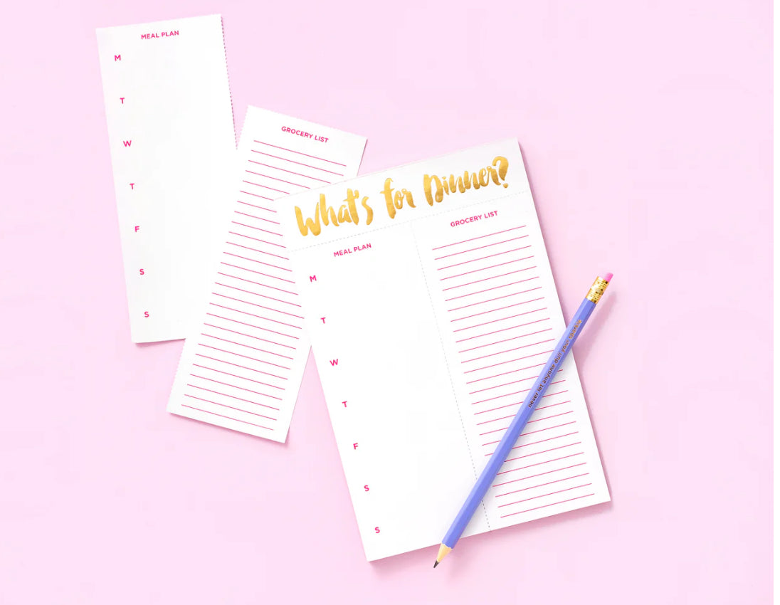 "What's For Dinner? meal planning notepad, perfect for organizing meals with ease. Size: 5.5" x 8.5", featuring 52 sheets with gold foil accents on each sheet. Includes a magnet on the back for easy display and comes in shrink-wrap packaging. 