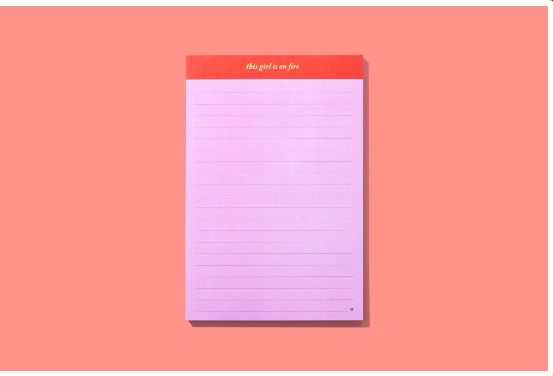 5.5" x 8.25" lined notebook with 75 sheets, imprinted with 'This girl is on fire.' Comes in shrink-wrap packaging. Perfect for note-taking or journaling. Imported.