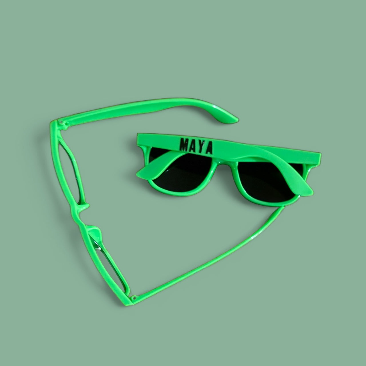 Personalized sunglasses with custom name printing, perfect for making a fashion statement. These trendy shades add personality to any outfit and help you stand out from the crowd. Ideal summer accessory for sunny days and a unique gift for friends.