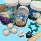 Hanukkah Play Dough Sensory Kit featuring festive activities designed for children, promoting sensory exploration and creativity, perfect for holiday gifting and classroom fun.