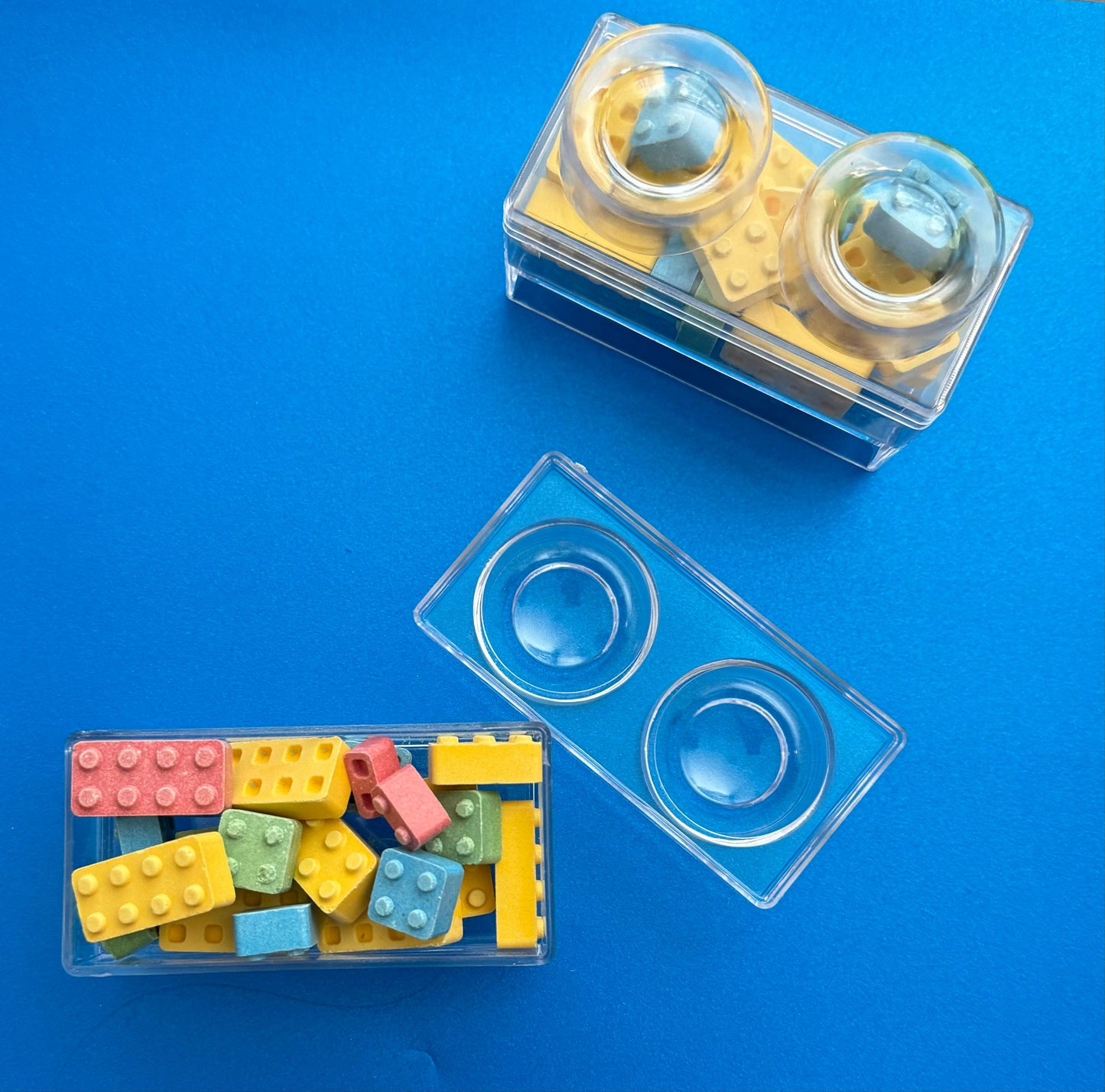 Block-themed candy favor in a brick-shaped box, perfect for birthday parties or playdates. Includes Lego-themed candies with optional cellophane wrap and thank you label. Custom candy containers available upon request.