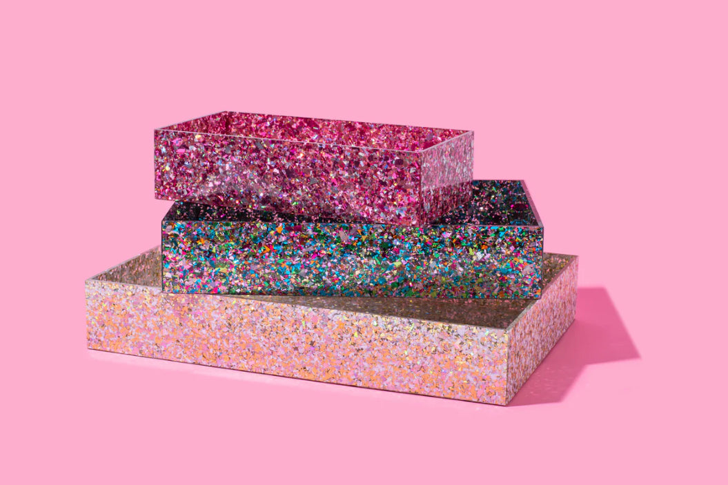 Add sparkle to your home or office with this 12x8 acrylic confetti tray, featuring a 2-inch height and pearl confetti mix. Perfect for guest bathrooms, coffee tables, or as a stylish desk tray. Elevate your decor with this imported, elegant accessory