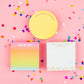 Colorful 3.5" x 3.5" sticky note pad with 300 sheets, imprinted with 'Throw Kindness Around Like Confetti.' Features a sticky adhesive backing and comes in shrink-wrap packaging. Confetti acrylic note holder sold separately. 