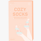 Cozy Socks Smoothing Foot Masks enriched with cocoa butter and peppermint oil, designed to hydrate and heal dry, cracked feet, featuring a fun fair isle print for a festive and relaxing self-care experience.