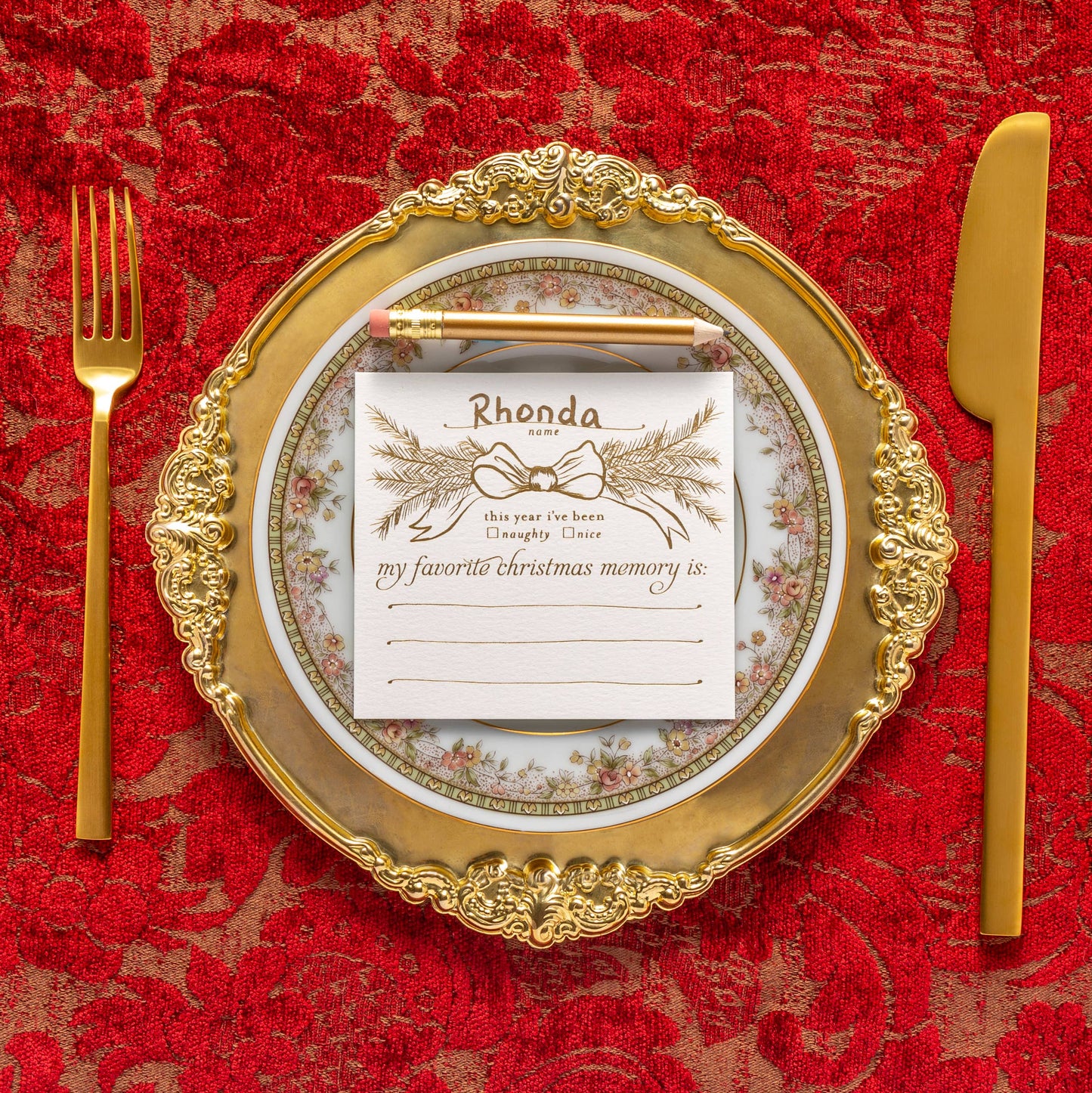 Interactive Christmas dinner party place cards with mini gold pencils, designed to spark holiday conversations and memories. Set of 8 foil-printed flat cards (4"x3.75") in a clear box, perfect for seating arrangements and table decor during festive gatherings.