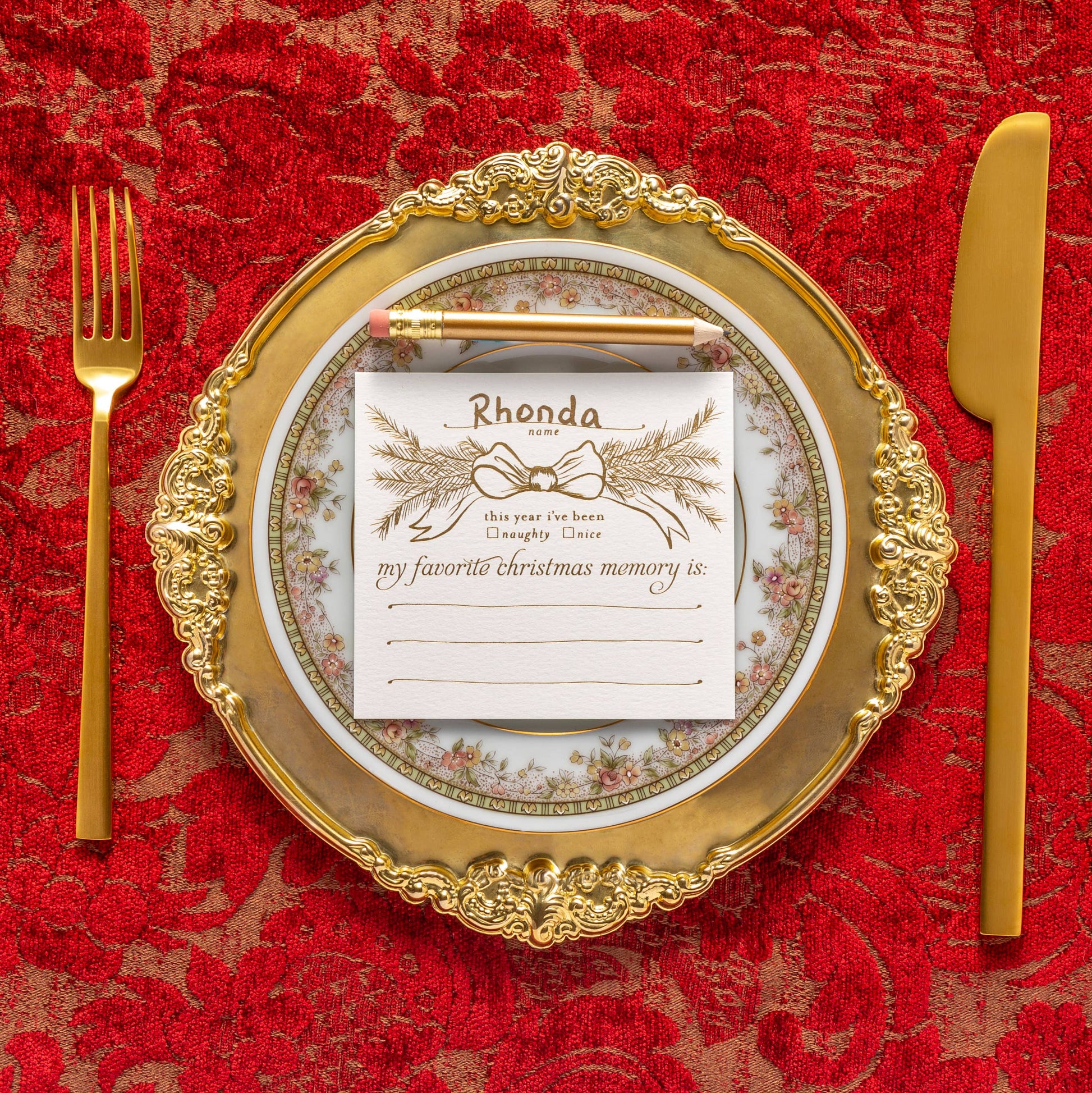 Interactive Christmas dinner party place cards with mini gold pencils, designed to spark holiday conversations and memories. Set of 8 foil-printed flat cards (4"x3.75") in a clear box, perfect for seating arrangements and table decor during festive gatherings.