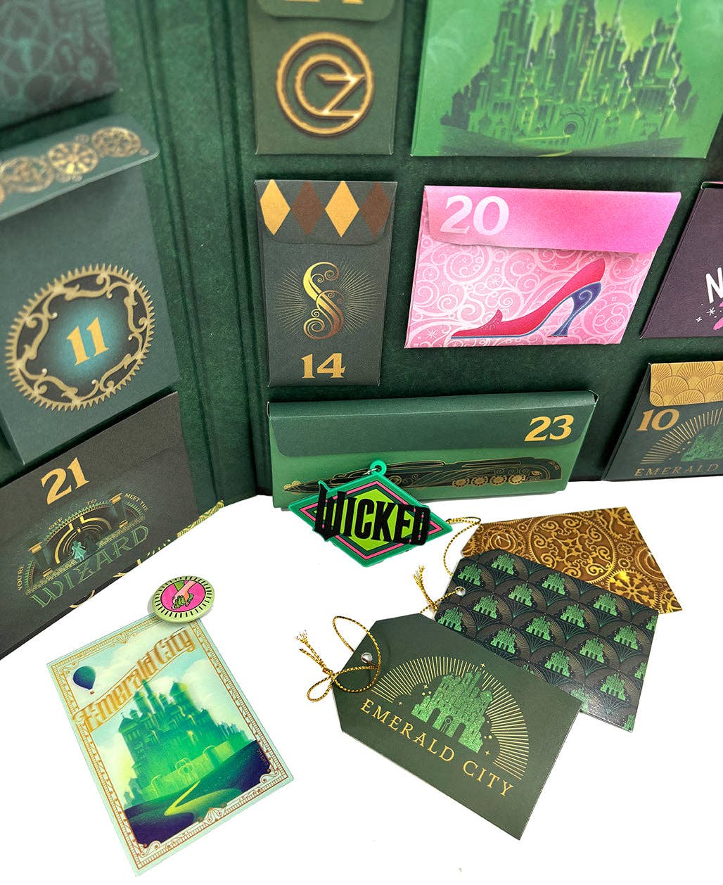 Wicked 25-Day Advent Calendar with collectible Oz-themed surprises, including patches, magnets, coasters, washi tape, and stickers. Perfect countdown gift for Wicked fans to celebrate the holiday season with daily Emerald City and Shiz University keepsakes.