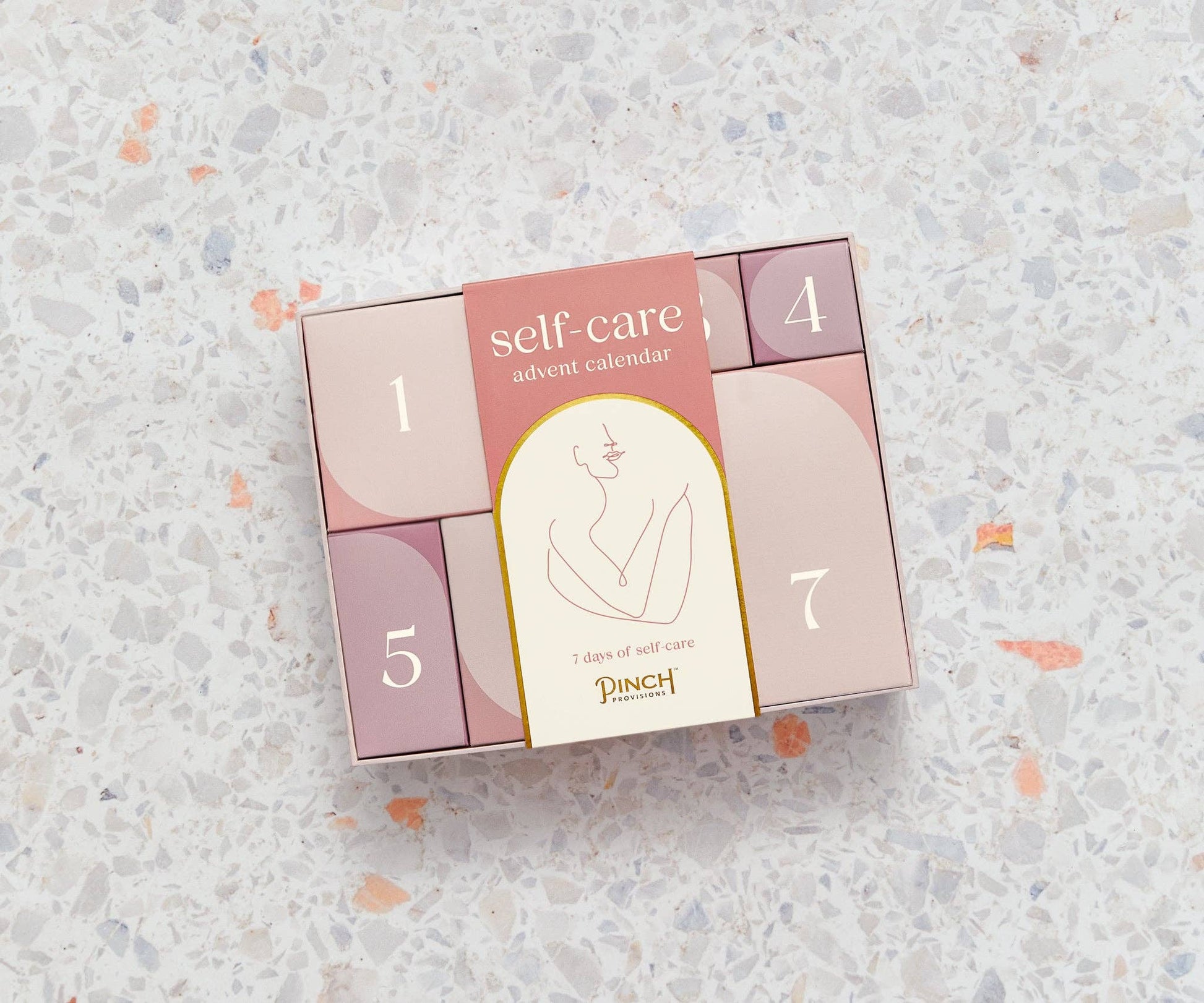 Self-Care Advent Calendar with 7 luxury surprises, including gua sha, candle, and spa essentials.