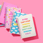 Hardcover notebook with motivational phrase, stars pattern, perforated pages, purple binding.