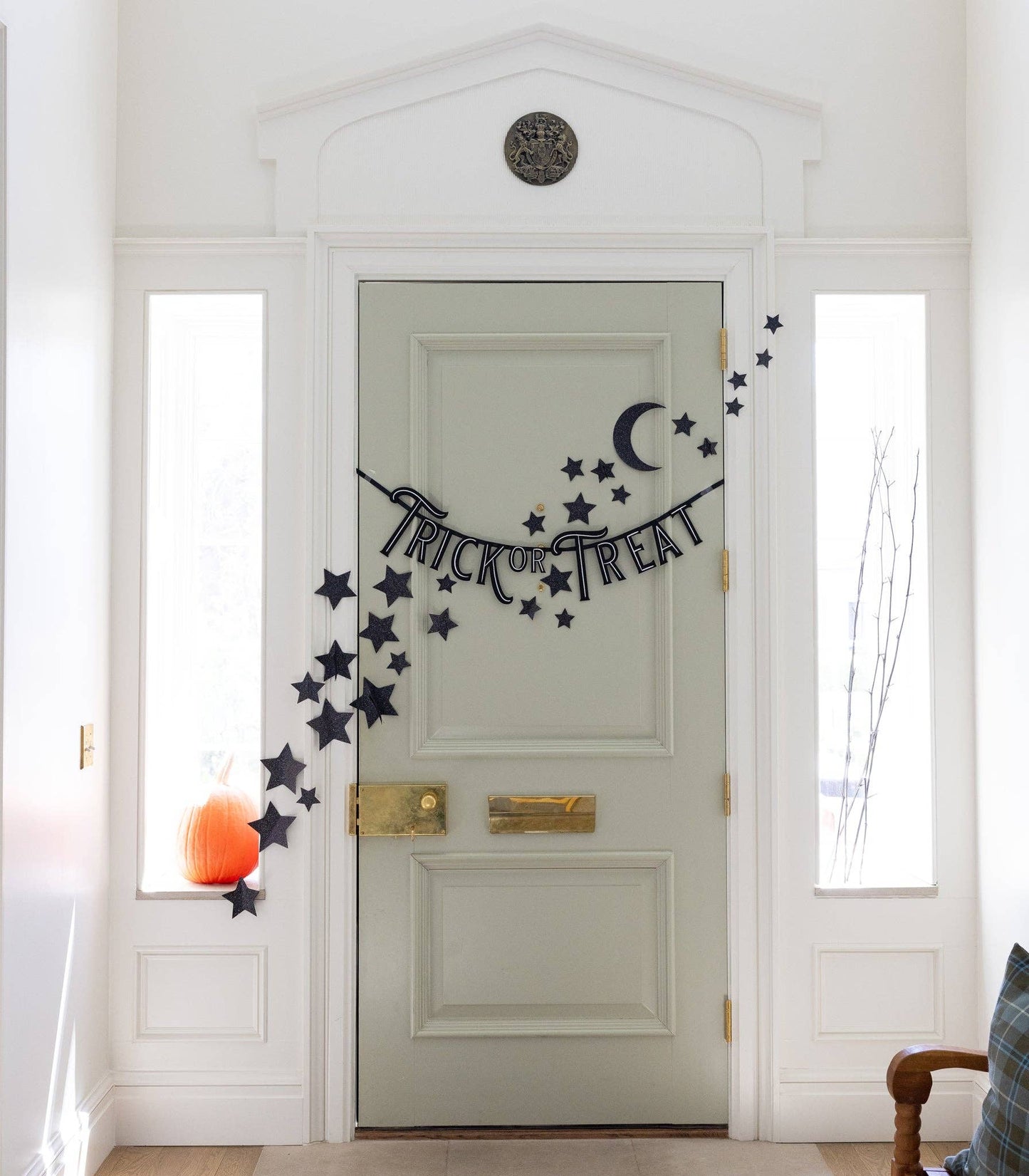 Black glitter star and moon wall décor, featuring 50 shimmering stars and 1 crescent moon, perfect for adding a magical touch to Halloween-themed spaces.