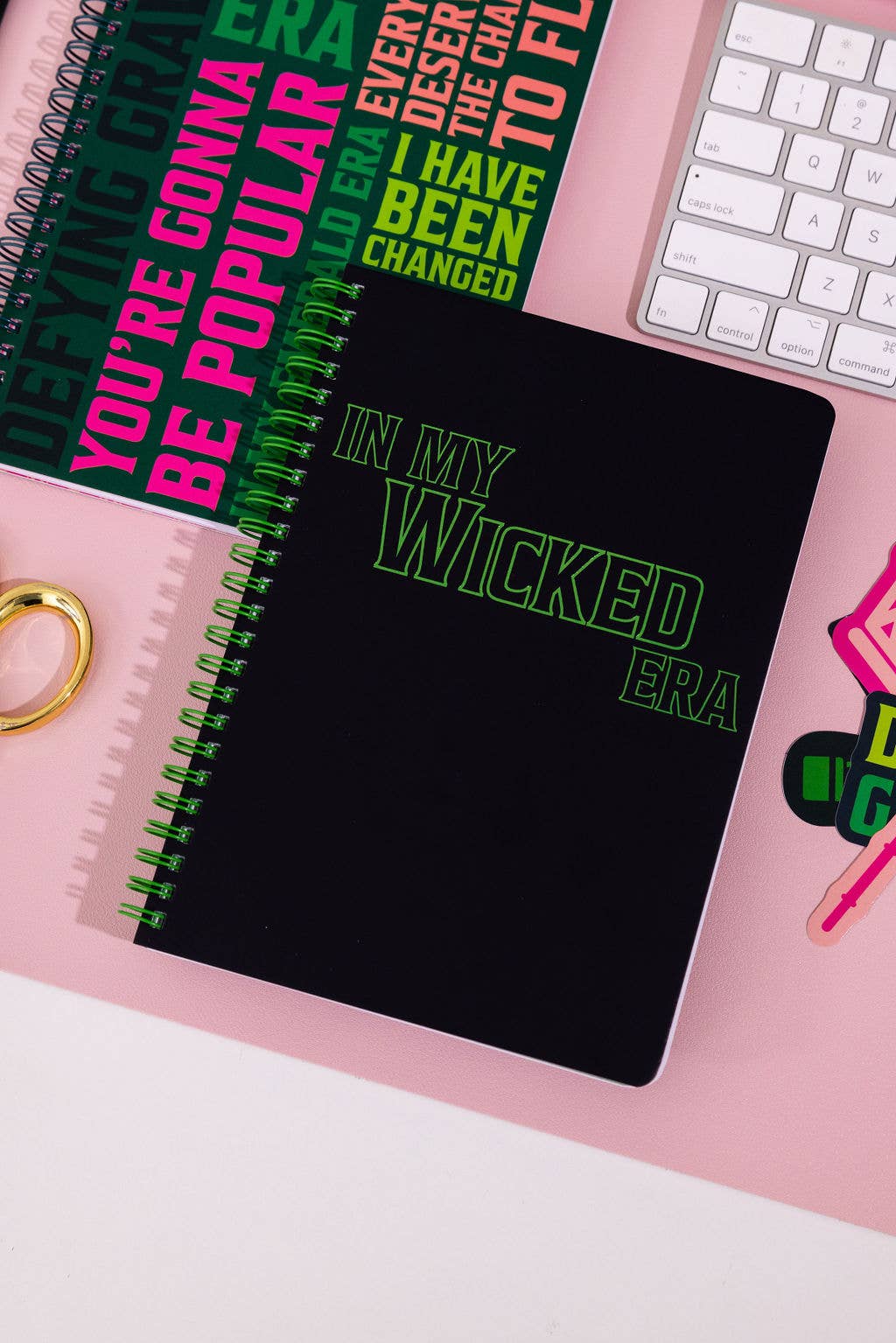 Wicked-inspired mini notebook with 160 college-ruled pages, durable hardcover, and convenient pockets.