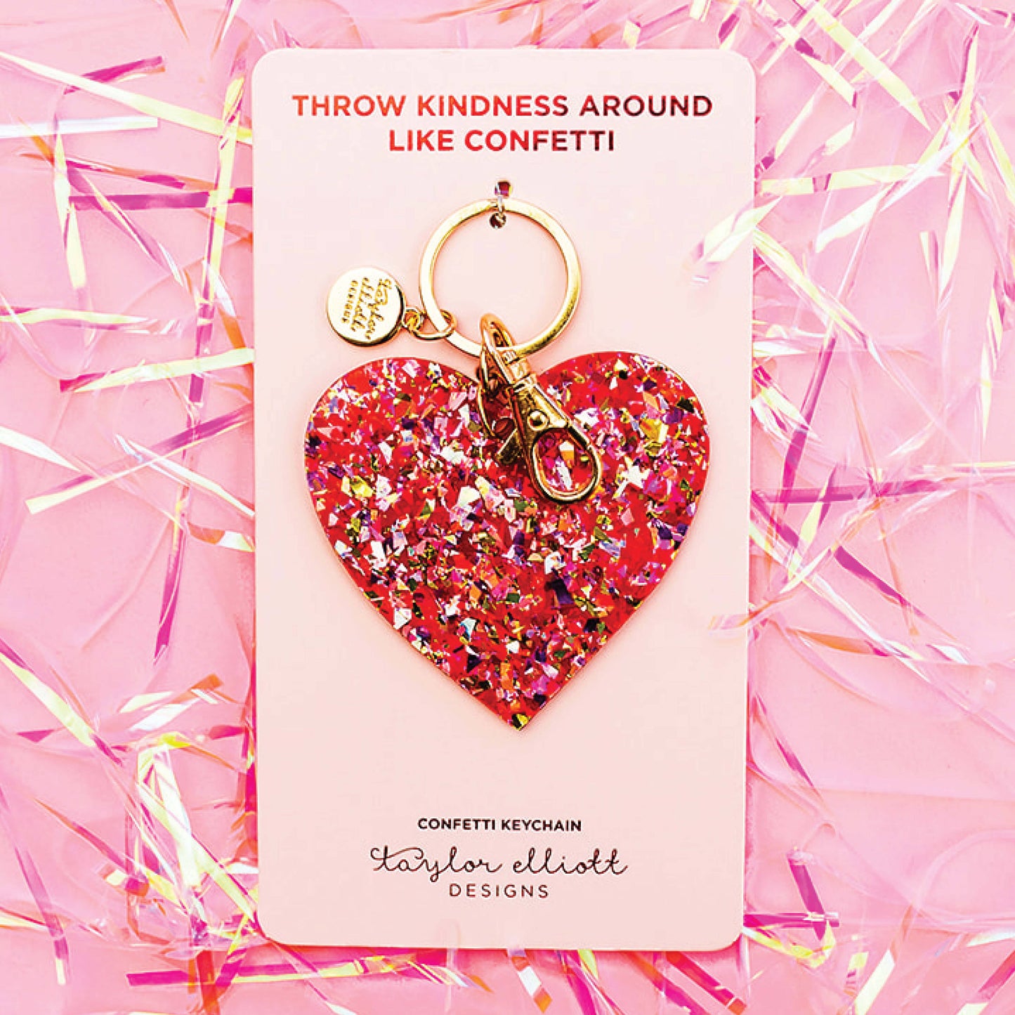 a heart shaped keychain on a pink background