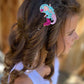 Cute glitter clips on fully lined glitter pinch clips, designed for kids’ hair. These sparkling hair accessories are perfect for everyday wear, adding a playful touch to any hairstyle. Fully lined for comfort, these clips feature a secure pinch mechanism, making them easy to use and ideal for young trendsetters.