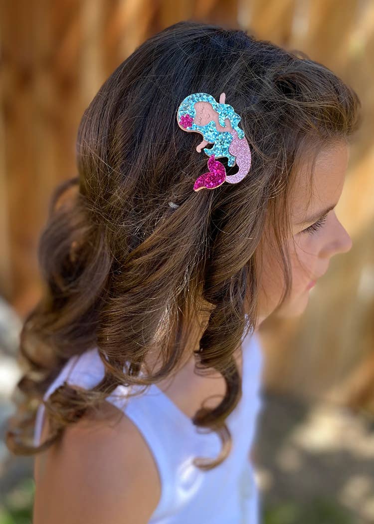 Cute glitter clips on fully lined glitter pinch clips, designed for kids’ hair. These sparkling hair accessories are perfect for everyday wear, adding a playful touch to any hairstyle. Fully lined for comfort, these clips feature a secure pinch mechanism, making them easy to use and ideal for young trendsetters.