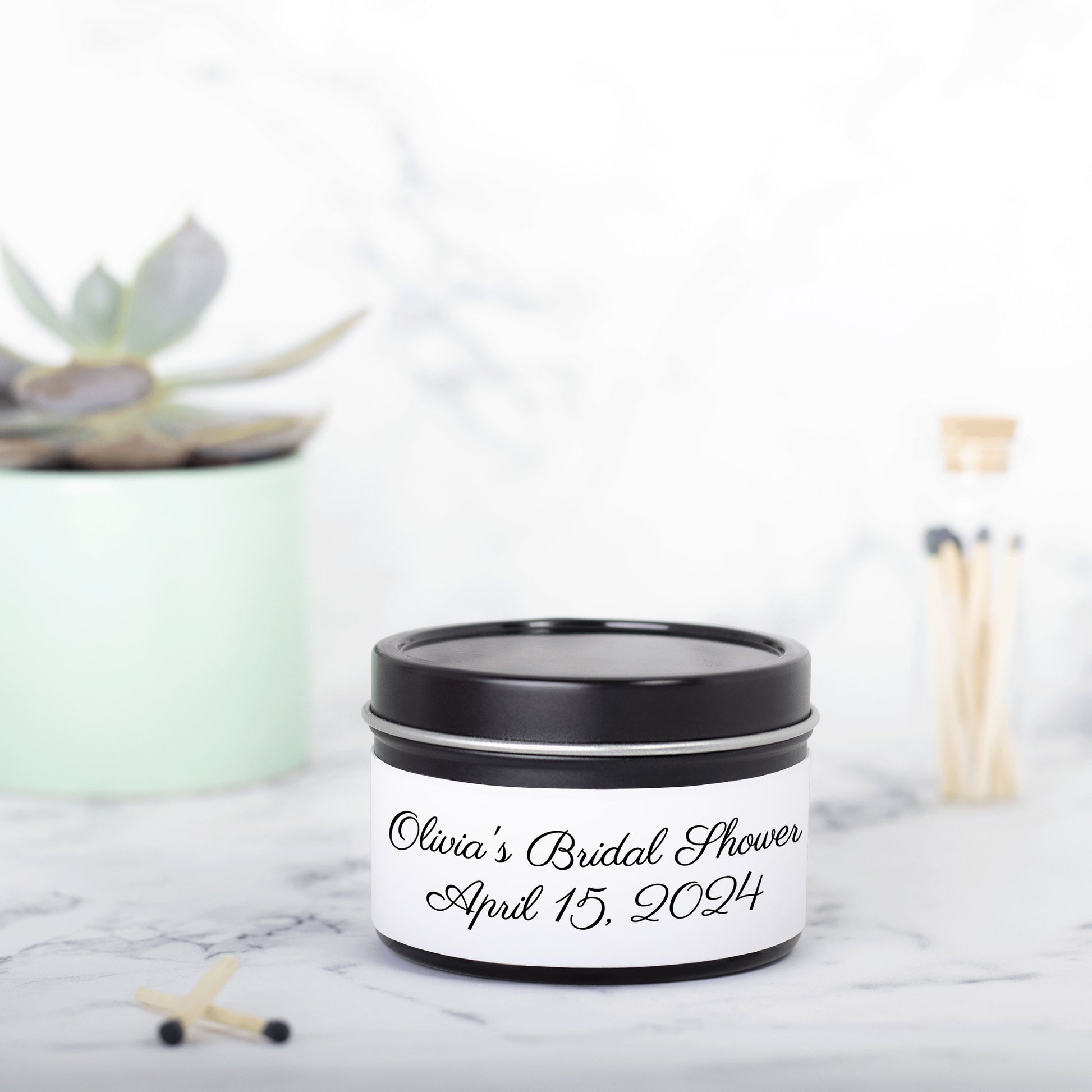 Personalized 4oz candle tins, perfect for bridal shower favors or invitations. Made with hand-poured coconut soy wax, featuring a lead-free cotton wick and custom labels with the bride's name and wedding date. Available in multiple aromatic scents