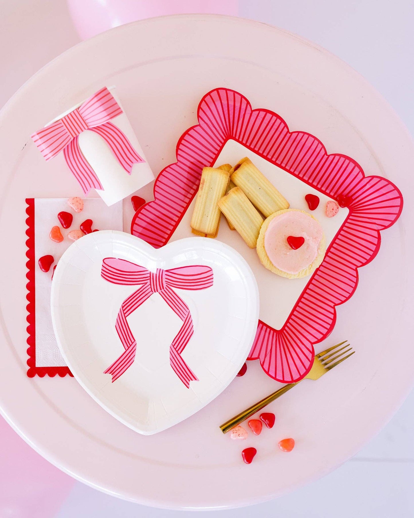 Tied Bow Heart Plates, 8 heart-shaped paper plates per pack, 9 x 9 inches, perfect for Valentine's Day celebrations or romantic dinners.