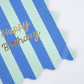 Colorful striped napkins with gold foil 'Happy Birthday' text, wavy edges, pack of 16.
