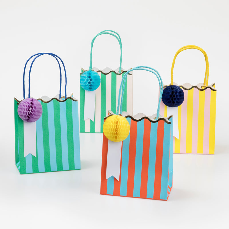 Colorful striped gift bags with honeycomb ball tags and gold metallic ties, pack of 8.