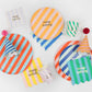 Colorful striped gift bags with honeycomb ball tags and gold metallic ties, pack of 8.