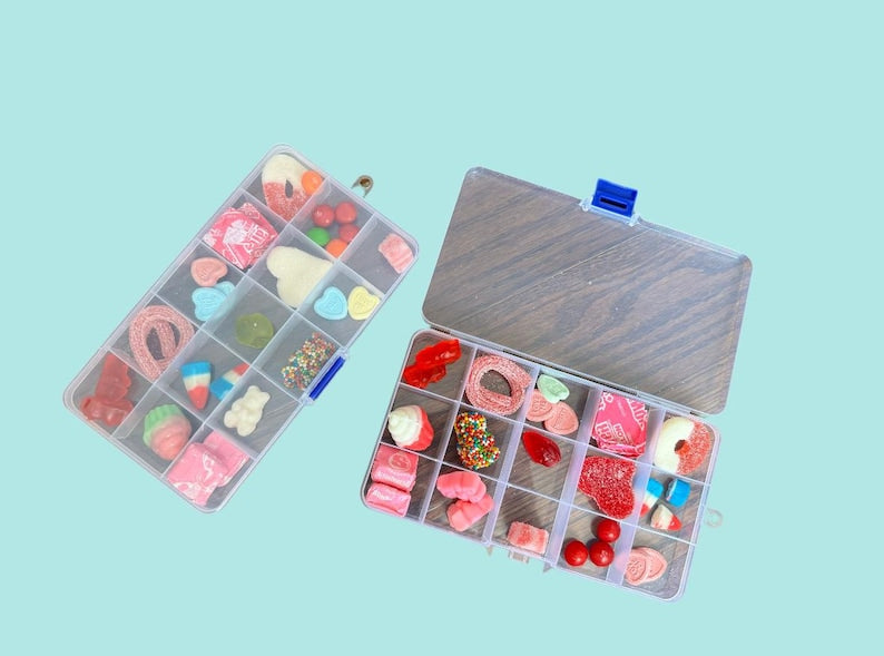 Clear box filled with colorful candies, offering a delightful assortment of sweet treats for candy lovers!